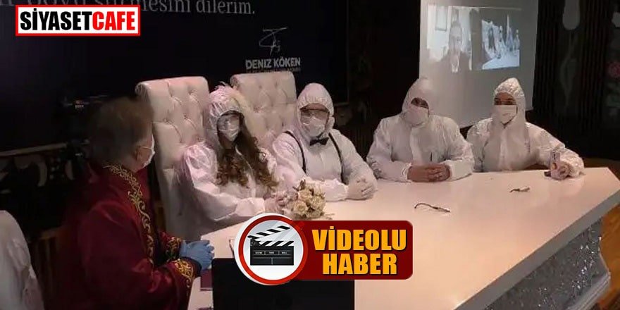 Sağlıkçı çift koruyucu tulumları ve maskeleriyle evlendi